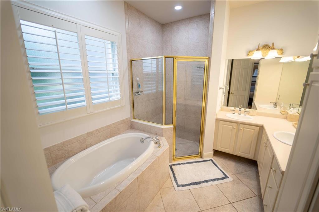 5886 Paradise Circle Naples, FL 34110 - Photo 10 of 19 Bathroom featuring tile patterned flooring, independent shower and bath, and vanity