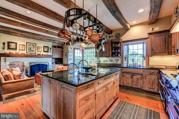 a living room with furniture a fireplace and a large window