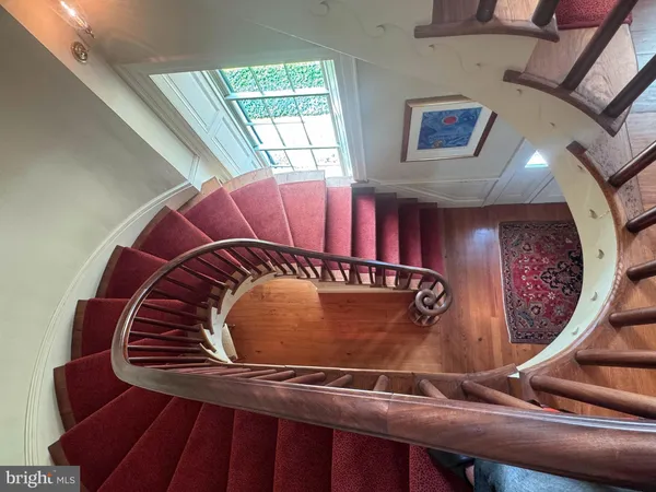 a dining room with furniture a chandelier and wooden floor