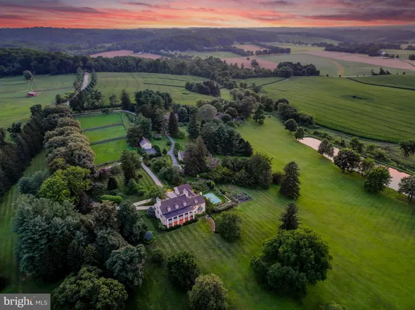 an aerial view of a golf course with a lake view