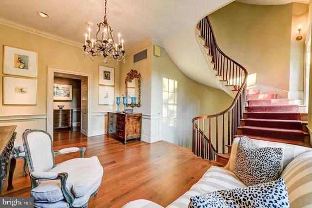 a balcony with wooden floor table and chairs