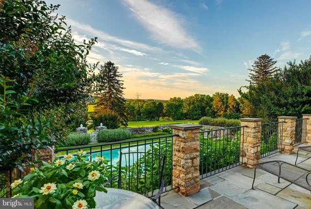 a view of garden with flowers and trees