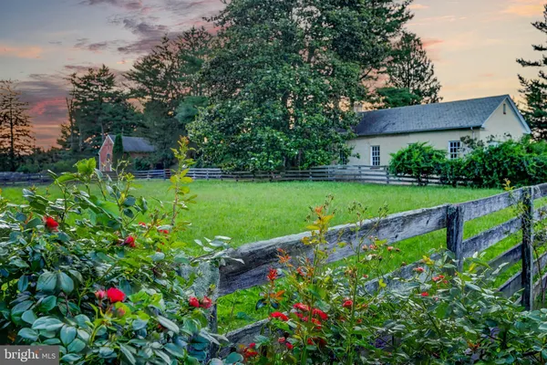 an aerial view of green landscape with trees houses and mountain view