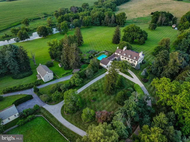 an aerial view of green landscape with trees houses and mountain view