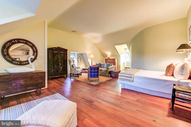 a living room with furniture or stairs and a wooden floor