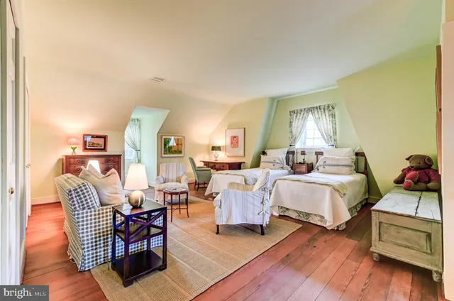 a view of a garden with plants and wooden fence