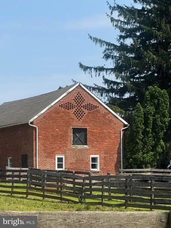 a front view of a house with a yard and potted plants