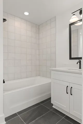 a bathroom with a bathtub a sink and a shower