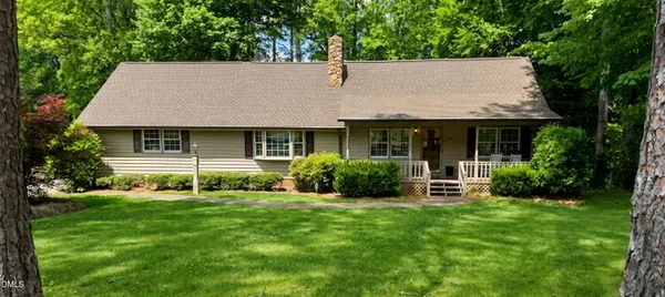 a aerial view of a house with a yard porch and sitting area