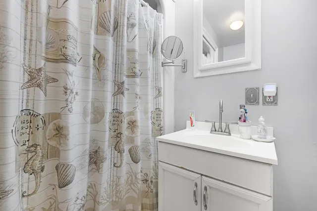 a bathroom with a sink vanity and a mirror