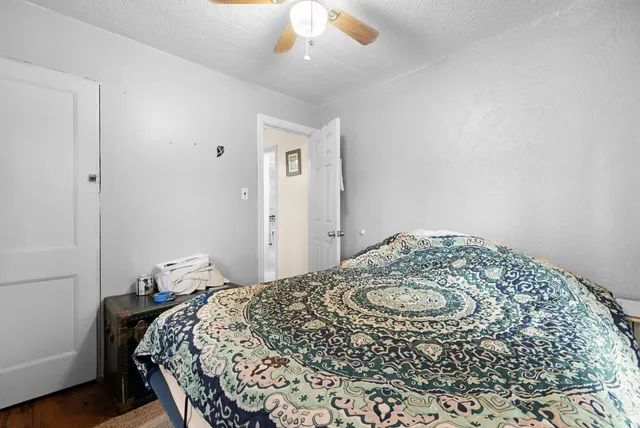 a bedroom with a bed and a table