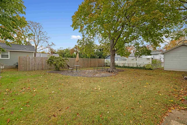a view of a backyard with a tree