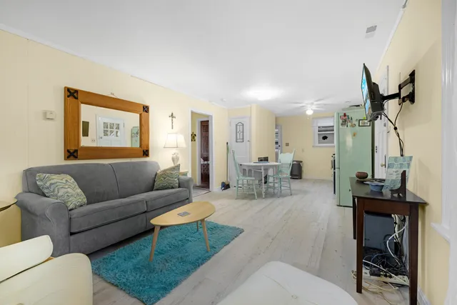 a living room with furniture a table and a painting