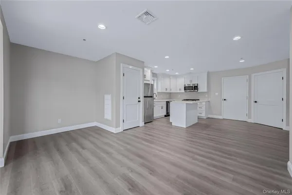 a kitchen with a white stove top oven and white cabinets