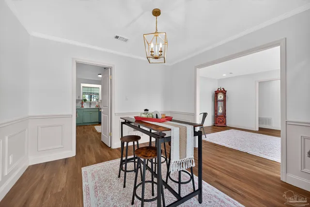 a kitchen with a sink cabinets and wooden floor