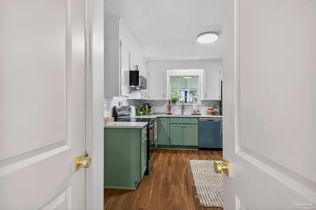 a kitchen with granite countertop a refrigerator and a counter top space