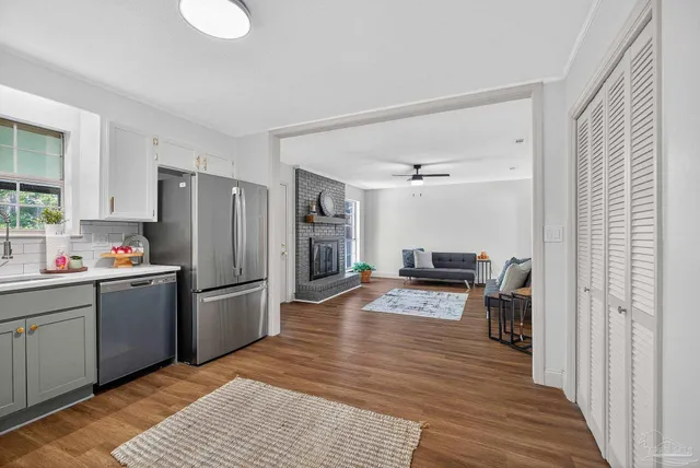 a kitchen with stainless steel appliances granite countertop a refrigerator sink and stove