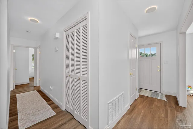 a bedroom with a bed and a chandelier fan