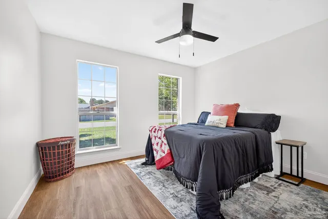 a view of backyard with table and chairs and a barbeque with wooden fence