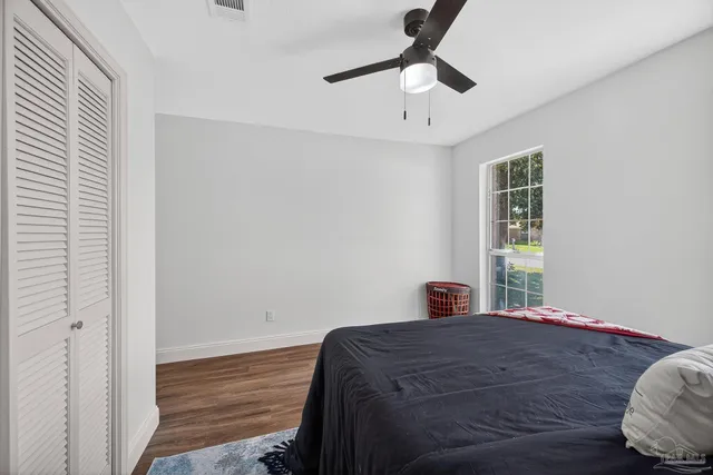 a front view of a house with yard and green space