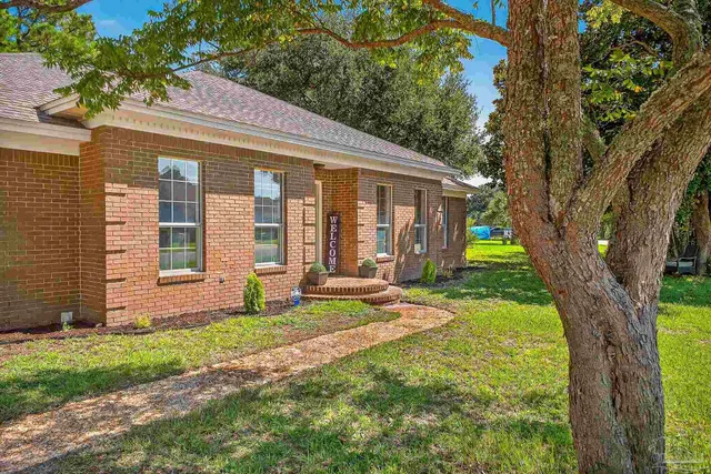 a view of a house with backyard porch and sitting area