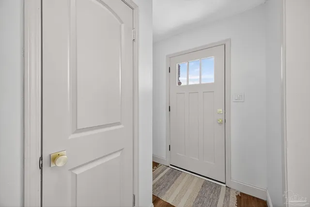 a view of an entryway with wooden floor