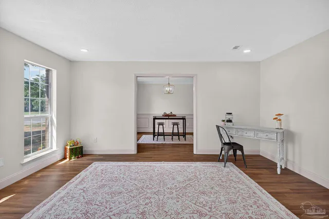a view of a livingroom with wooden floor and a window