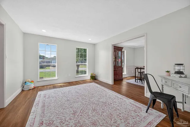 a view of a dining room with furniture and wooden floor