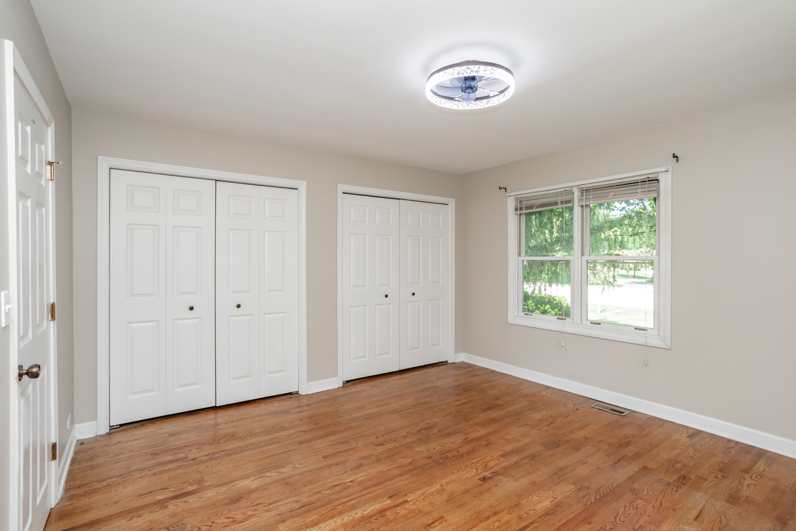 15W271 91st Street Burr Ridge, IL 60527 - Photo 11 of 30 a view of an empty room with wooden floor and a window