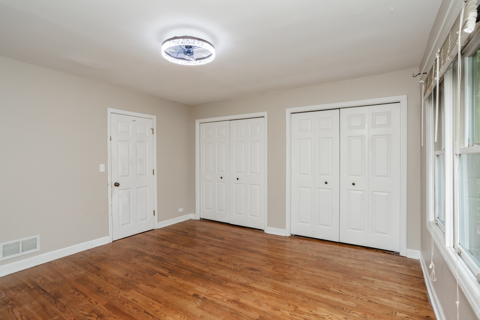 15W271 91st Street Burr Ridge, IL 60527 - Photo 12 of 30 a view of an empty room with wooden floor and a window