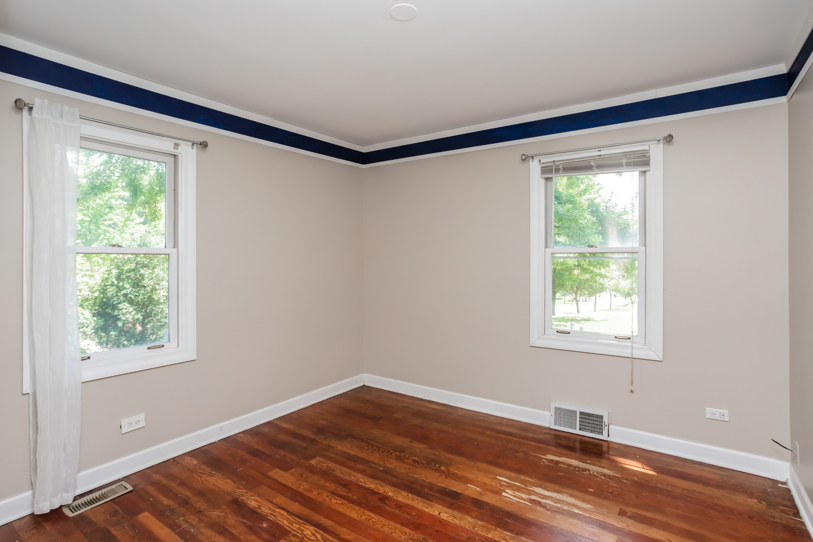 15W271 91st Street Burr Ridge, IL 60527 - Photo 14 of 30 a view of an empty room with wooden floor and a window