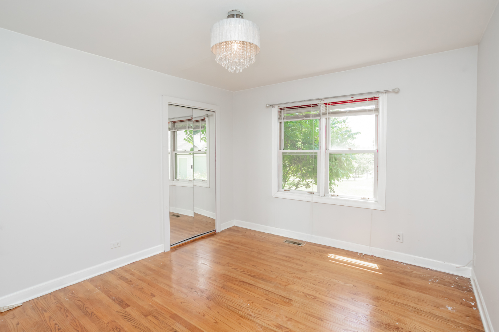 15W271 91st Street Burr Ridge, IL 60527 - Photo 16 of 30 an empty room with wooden floor and windows