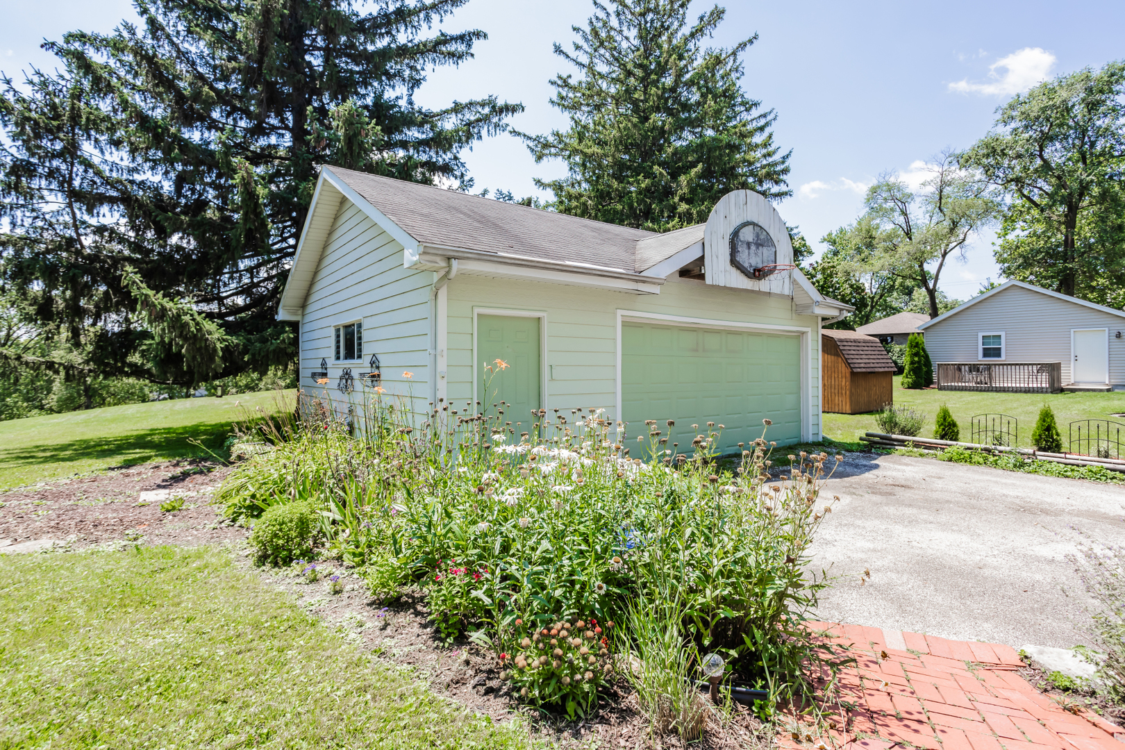 15W271 91st Street Burr Ridge, IL 60527 - Photo 25 of 30 a view of a house with a yard and potted plants