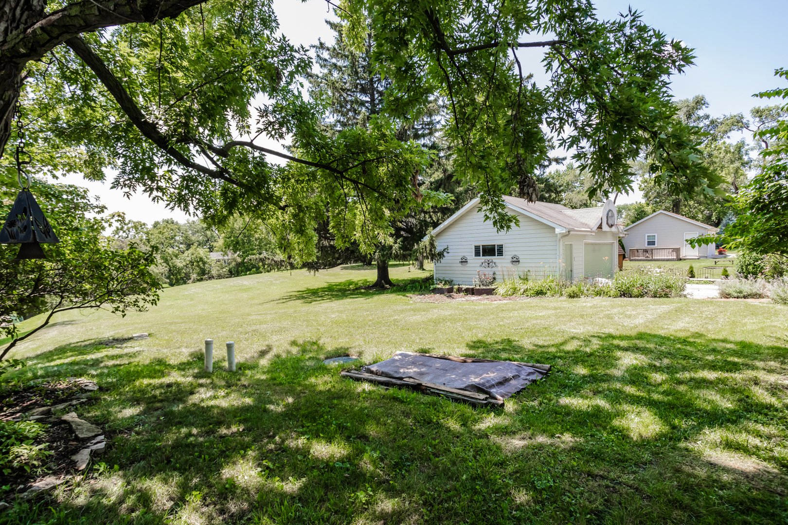 15W271 91st Street Burr Ridge, IL 60527 - Photo 29 of 30 a view of a white house with a yard and large trees