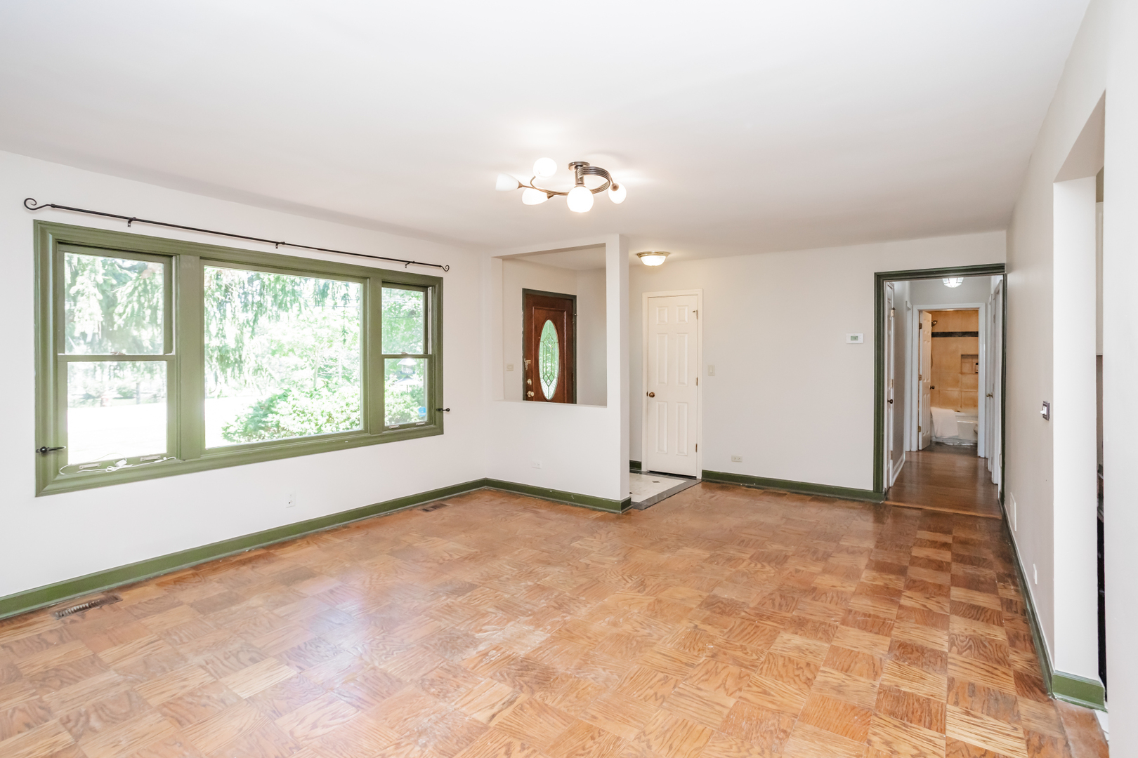 15W271 91st Street Burr Ridge, IL 60527 - Photo 4 of 30 an empty room with windows and chandelier fan