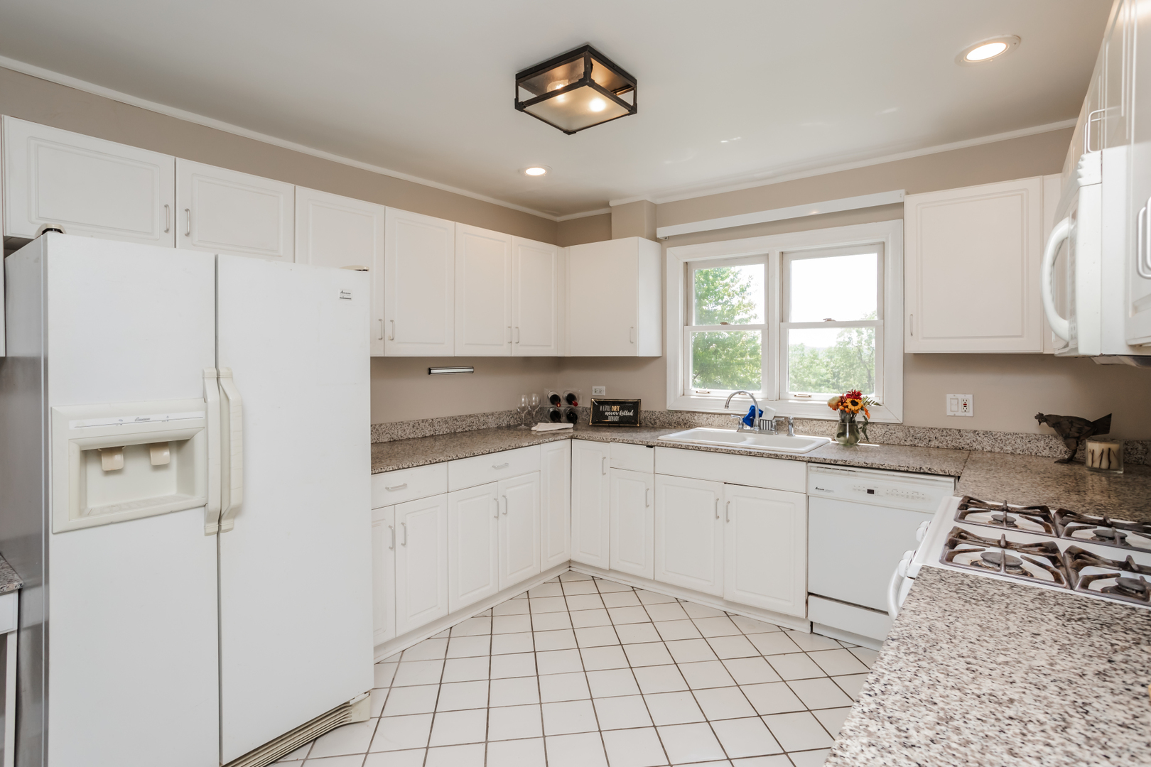 15W271 91st Street Burr Ridge, IL 60527 - Photo 7 of 30 a kitchen with white cabinets and white appliances