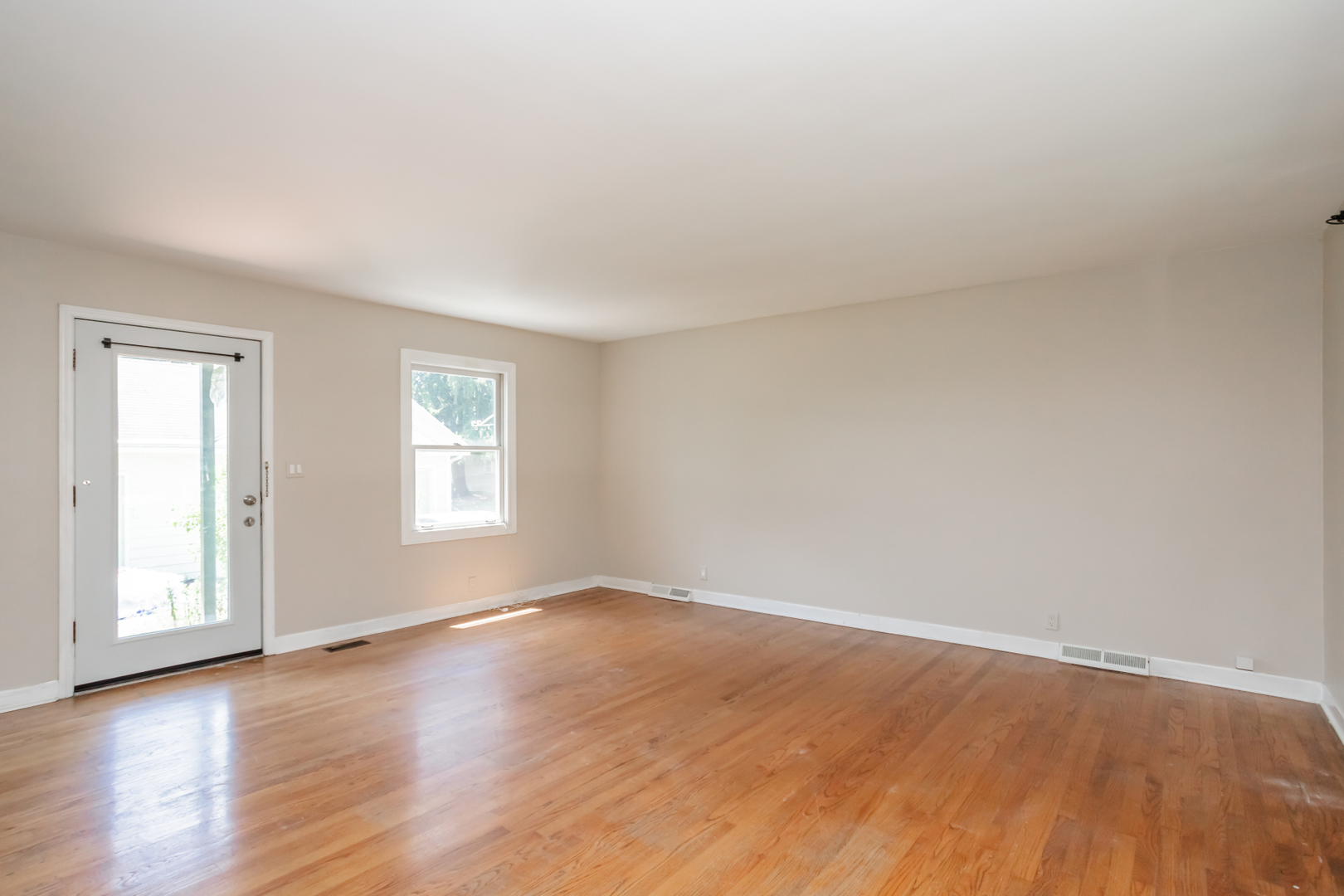 15W271 91st Street Burr Ridge, IL 60527 - Photo 9 of 30 a view of an empty room with wooden floor and a window