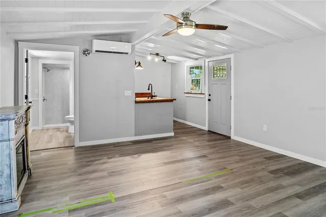 a view of a kitchen with wooden floor and a ceiling fan