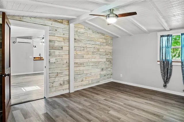 a view of a room with wooden floor