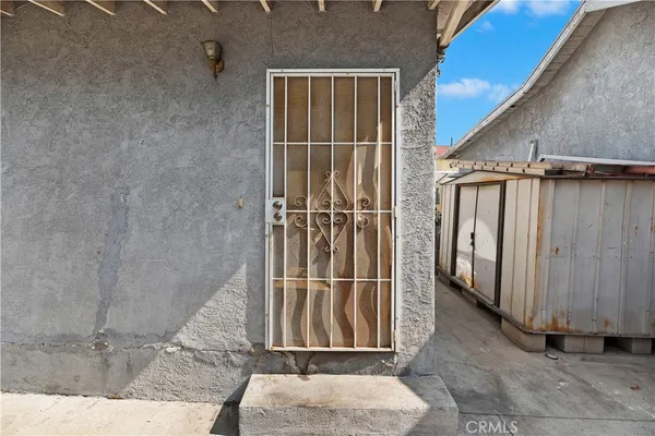 a view of a house with a wooden fence