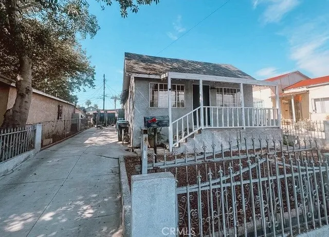 a view of a house with wooden fence