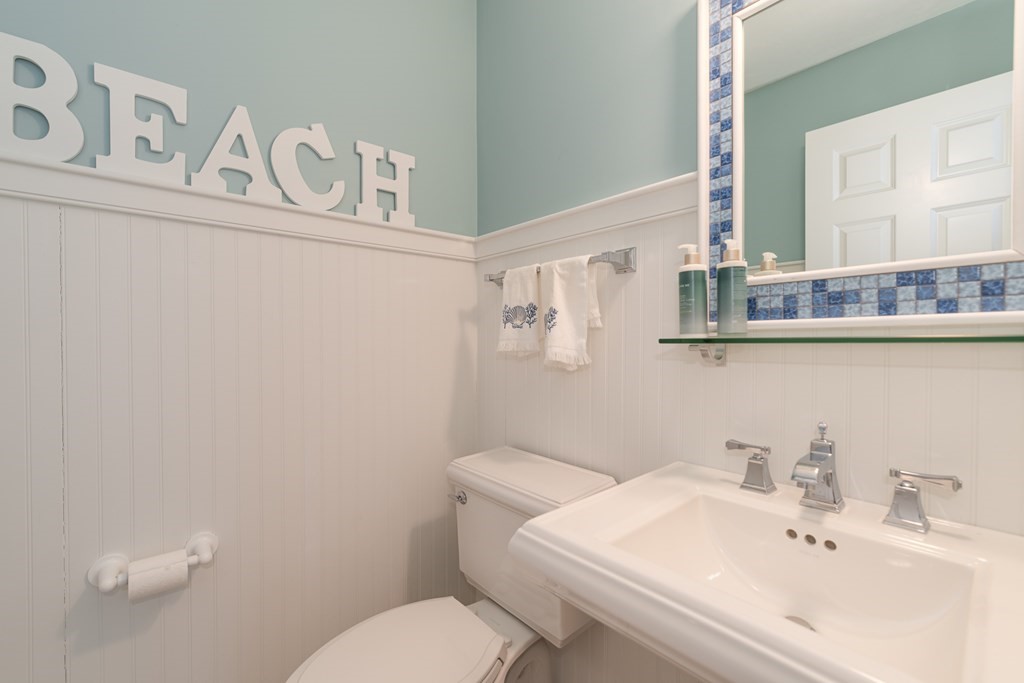 23 Gold Leaf Lane, Unit 23 Mashpee, MA 02649 - Photo 18 of 32 a bathroom with a sink a toilet and mirror