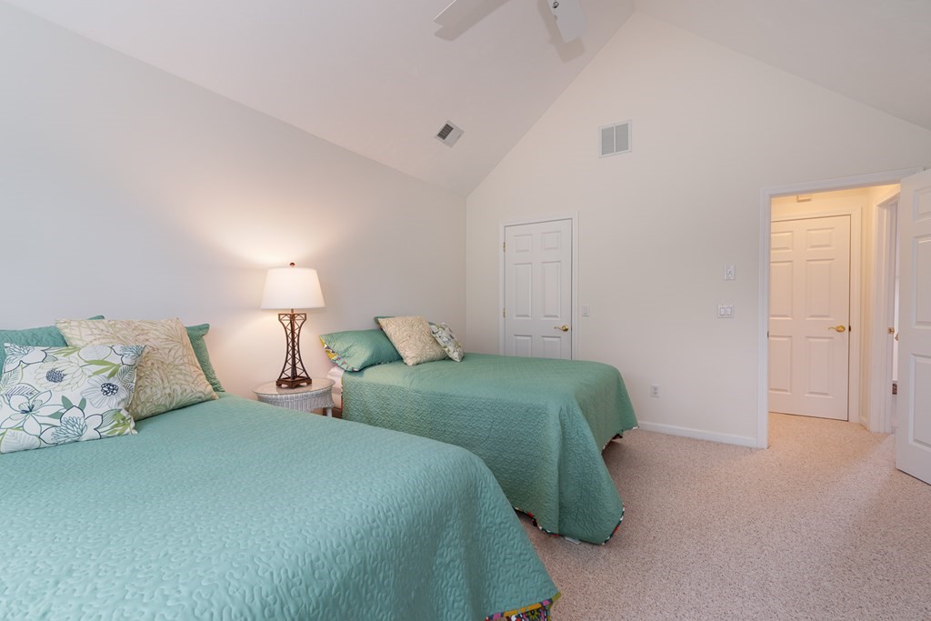 23 Gold Leaf Lane, Unit 23 Mashpee, MA 02649 - Photo 20 of 32 a bedroom with two beds and painting on the wall
