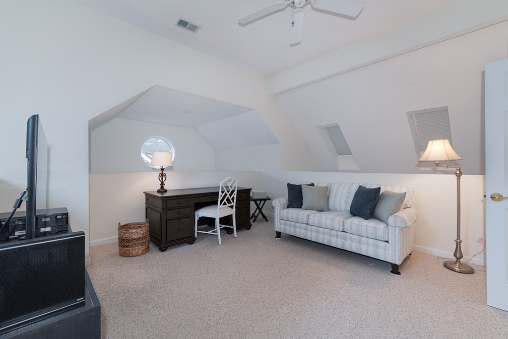 23 Gold Leaf Lane, Unit 23 Mashpee, MA 02649 - Photo 21 of 32 a living room with furniture and a fireplace