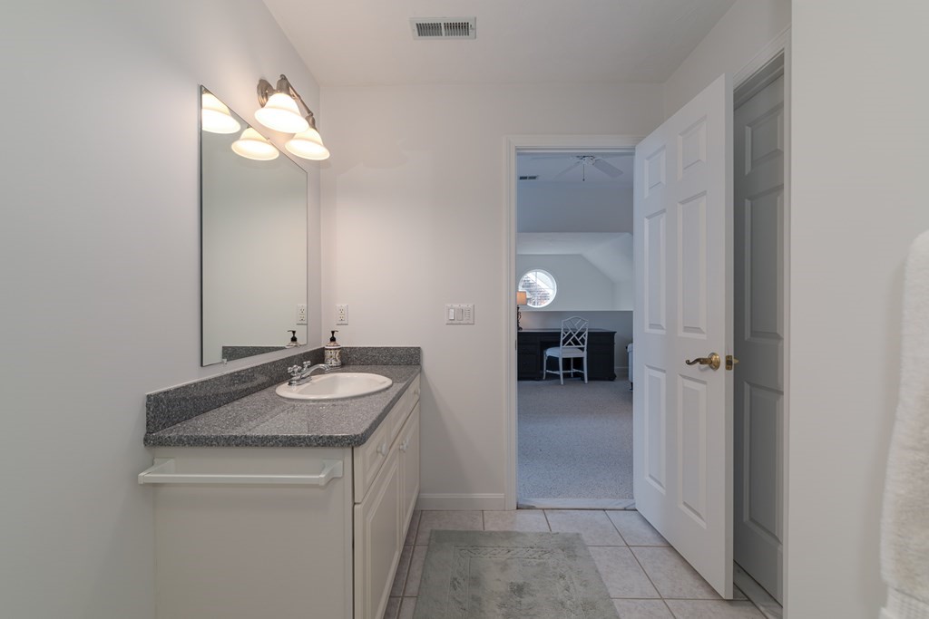 23 Gold Leaf Lane, Unit 23 Mashpee, MA 02649 - Photo 24 of 32 a bathroom with a sink and a mirror