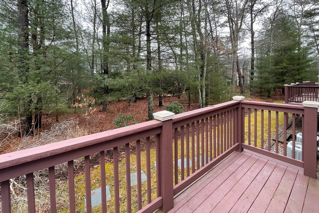 23 Gold Leaf Lane, Unit 23 Mashpee, MA 02649 - Photo 26 of 32 a view of a wooden deck with trees