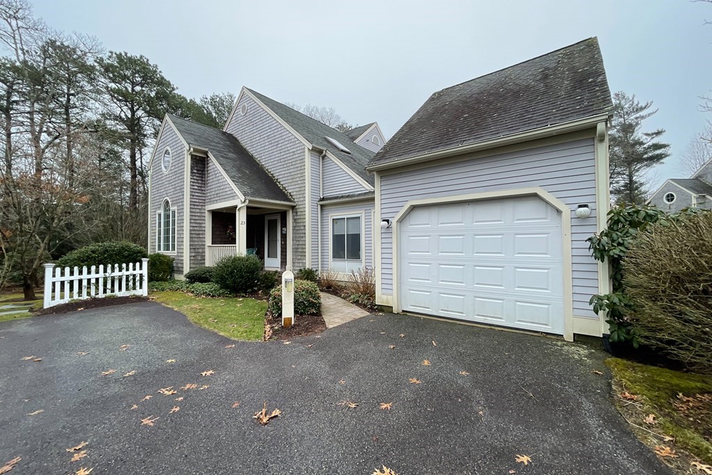 23 Gold Leaf Lane, Unit 23 Mashpee, MA 02649 - Photo 28 of 32 a front view of a house with a yard