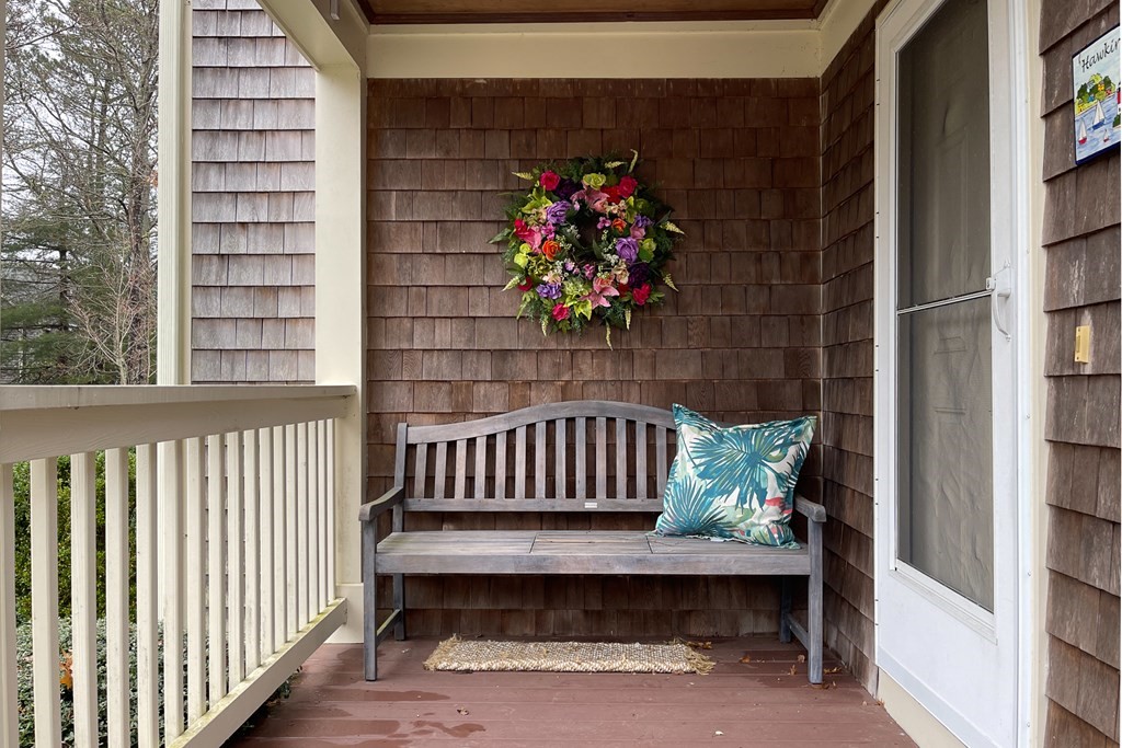 23 Gold Leaf Lane, Unit 23 Mashpee, MA 02649 - Photo 29 of 32 a view of a porch with a bench