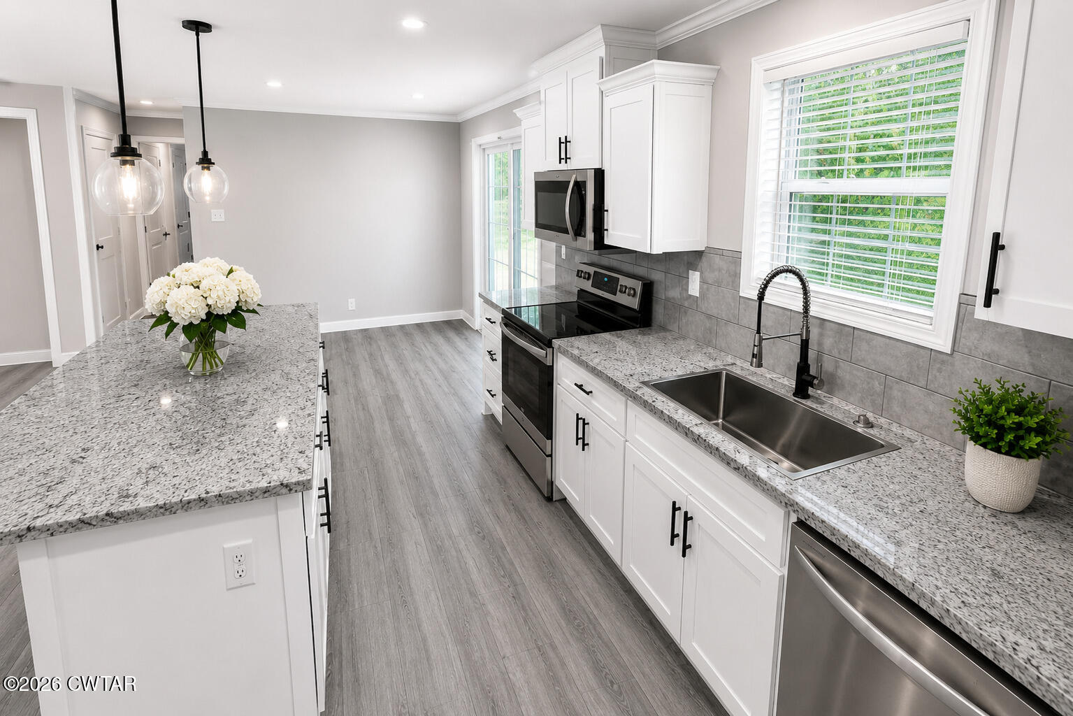 398 Pope Road Lexington, TN 38351 - Photo 6 of 21 a kitchen with stainless steel appliances granite countertop a sink a stove and a wooden floors