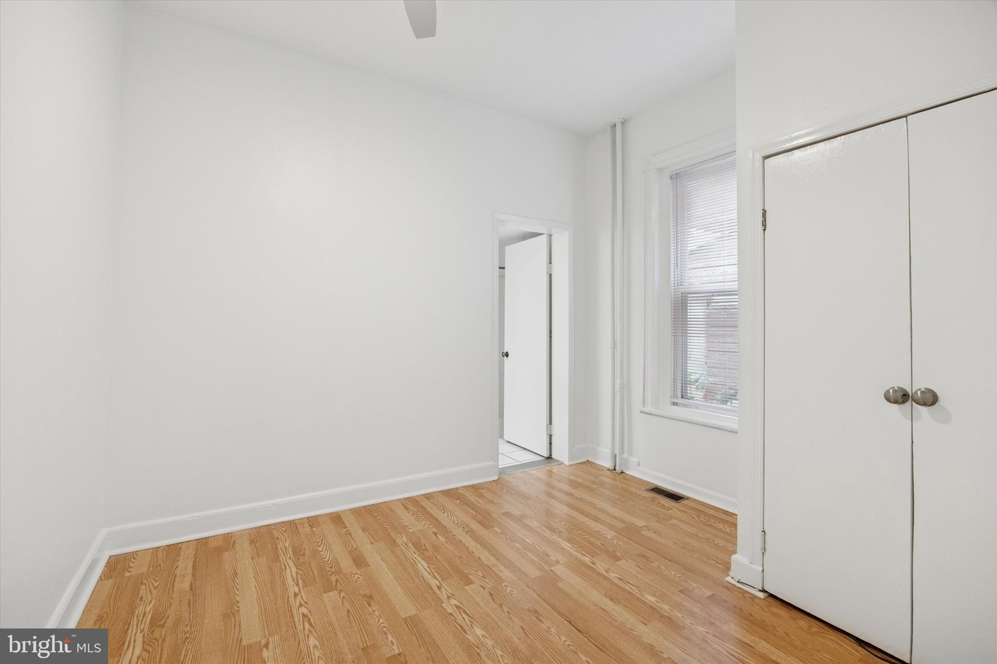 236 Buckingham Place Philadelphia, PA 19104 - Photo 6 of 11 a view of a bedroom with wooden floor and closet